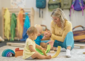 Woman,Two children,Green and yellow toy,Backpack,Yellow shirt